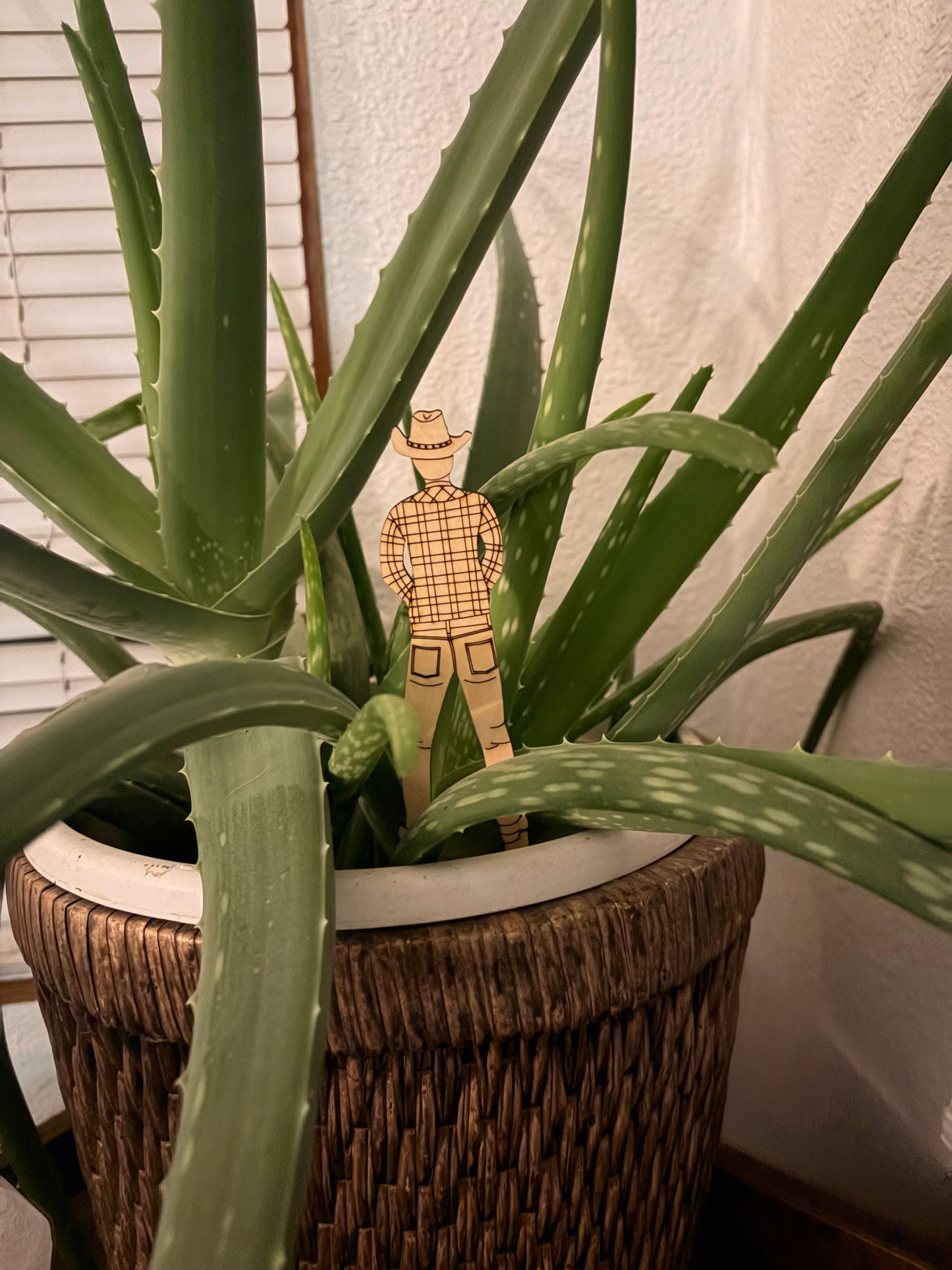 Wooden Cowboy Peeing on the Plant